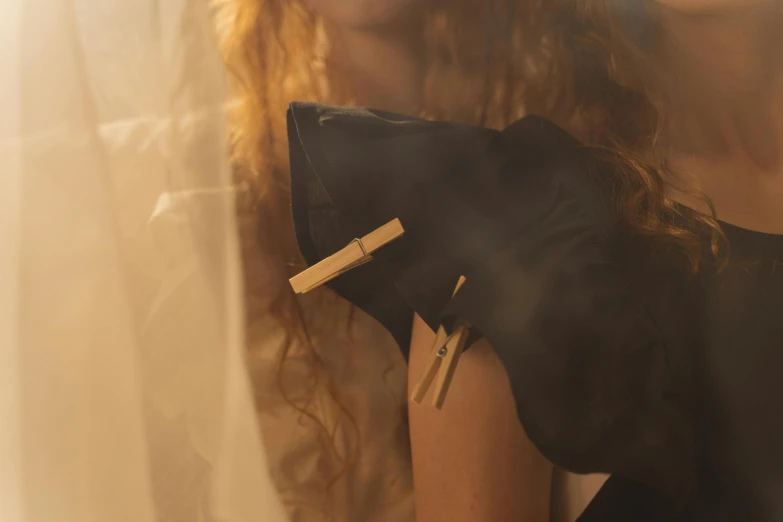 a woman in a black dress holding a black purse, an album cover, inspired by Albert Edelfelt, unsplash, renaissance, thin soft hand holding cigarette, morning detail, put on a mannequin, dreamy atmospheric