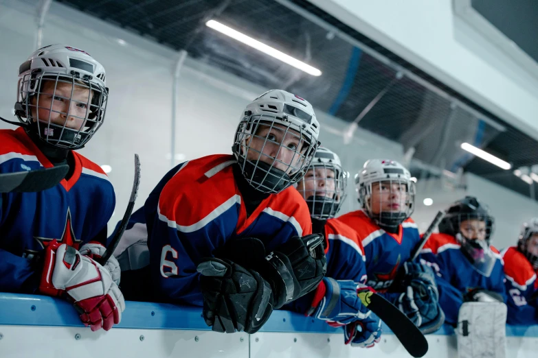 a group of young hockey players sitting on a bench, pexels contest winner, helmet view, female, thumbnail, 8/8