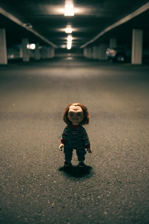 a creepy doll sitting in the middle of a parking garage, inspired by Sam Havadtoy, unsplash, chucky, nendoroid, nights, standing in road