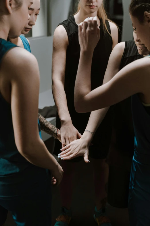 a group of women standing around each other, inspired by Nan Goldin, trending on unsplash, renaissance, prayer hands, tournament, ignant, high angle