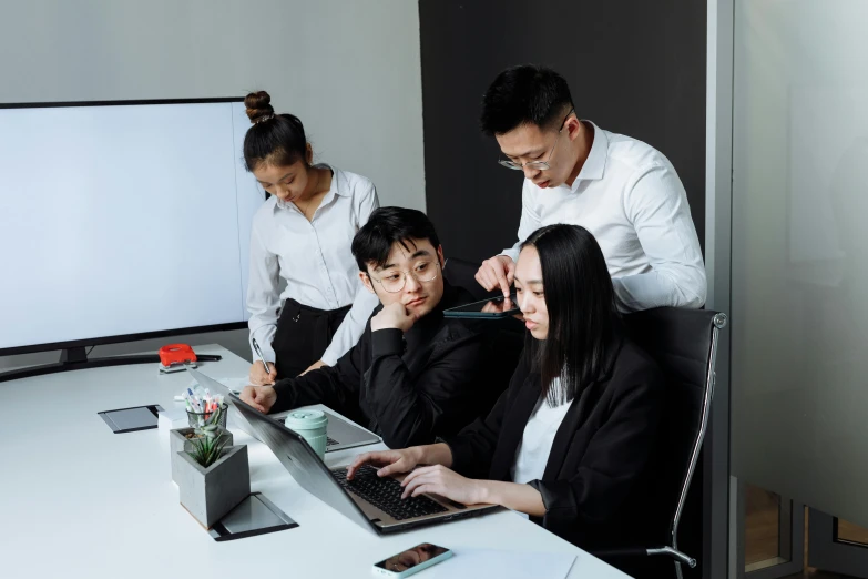 a group of people sitting around a table with a laptop, on a desk, darren quach, avatar image, high quality image