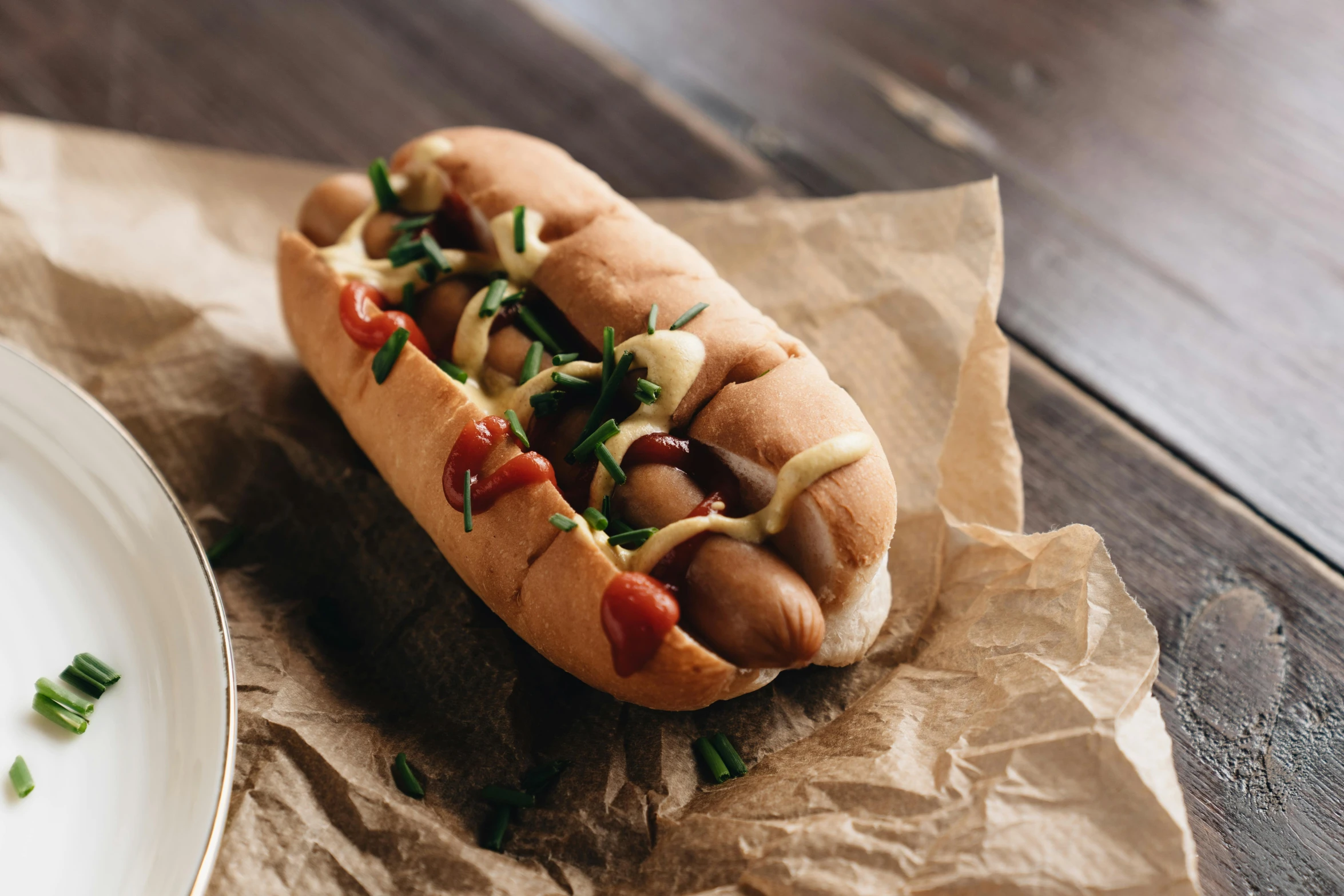 a hot dog sitting on top of a white plate, by Emma Andijewska, unsplash, renaissance, on old parchment paper, steamed buns, high quality product image”, background image