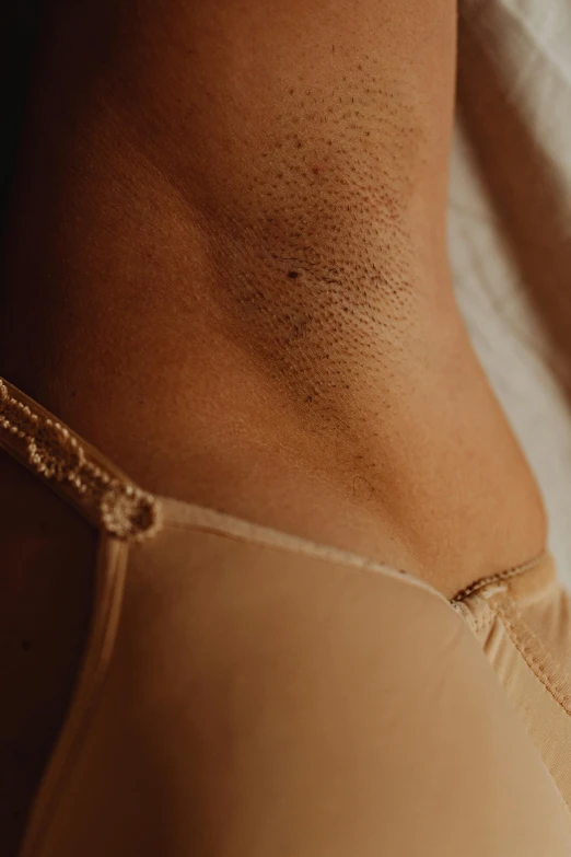 a close up of a person wearing a bra, wax skin, subtle detailing, stomach skin, mid-shot