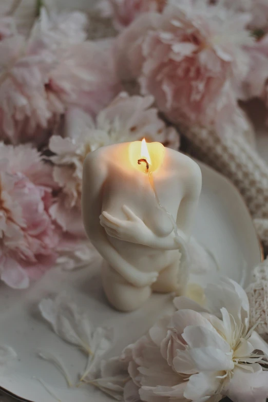 a white candle sitting on top of a white plate, a marble sculpture, by Zofia Stryjenska, romanticism, loving embrace, soft bloom lighting, singularity sculpted �ー etsy, with a soft