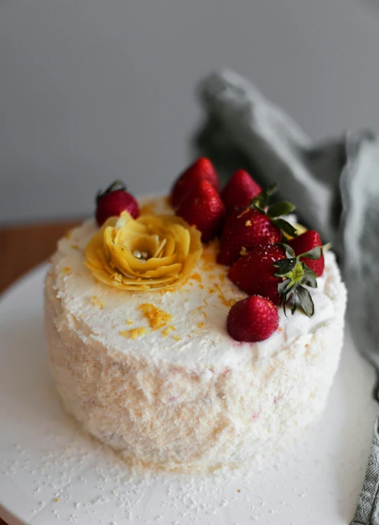 a close up of a cake with strawberries on a plate