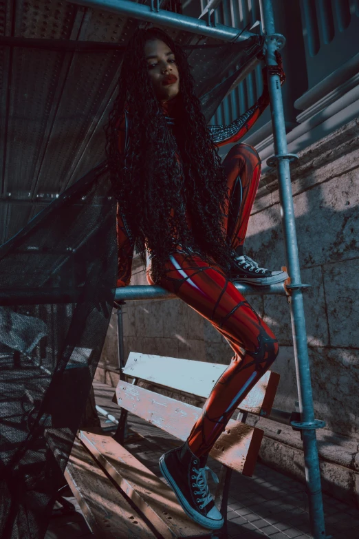 a woman sitting on top of a wooden bench, inspired by Elsa Bleda, afrofuturism, wearing a black and red suit, spiderman in the moshpit, high boots, instagram photo