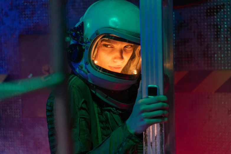 a close up of a person wearing a helmet, inspired by Elsa Bleda, inside a space station, natalia dyer, fluorescent, emma watson vietnam door gunner