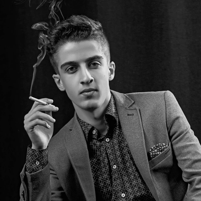 a black and white photo of a man smoking a cigarette, an album cover, inspired by Ahmed Yacoubi, cai xukun, suit and tie, dr zeus, attractive young man