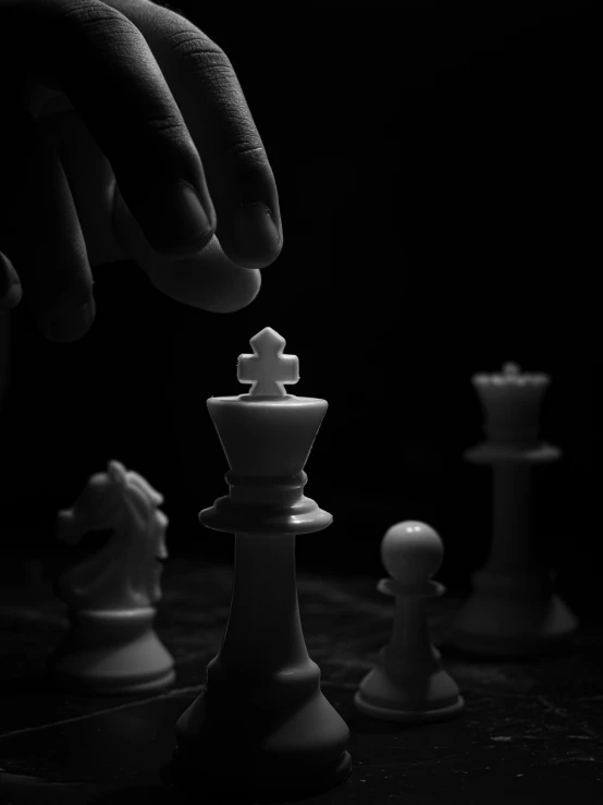 a black and white photo of a person playing chess, by Kristian Kreković, pexels contest winner, synthetism, queen chess piece, chiaroscuro!!, cinematic. by leng jun, white on black