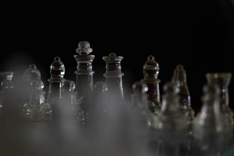 a group of glass chess pieces sitting on top of a table, a macro photograph, unsplash, process art, enveloped in ghosts, bottles, close-up photo, shot with canon 5 d mark ii
