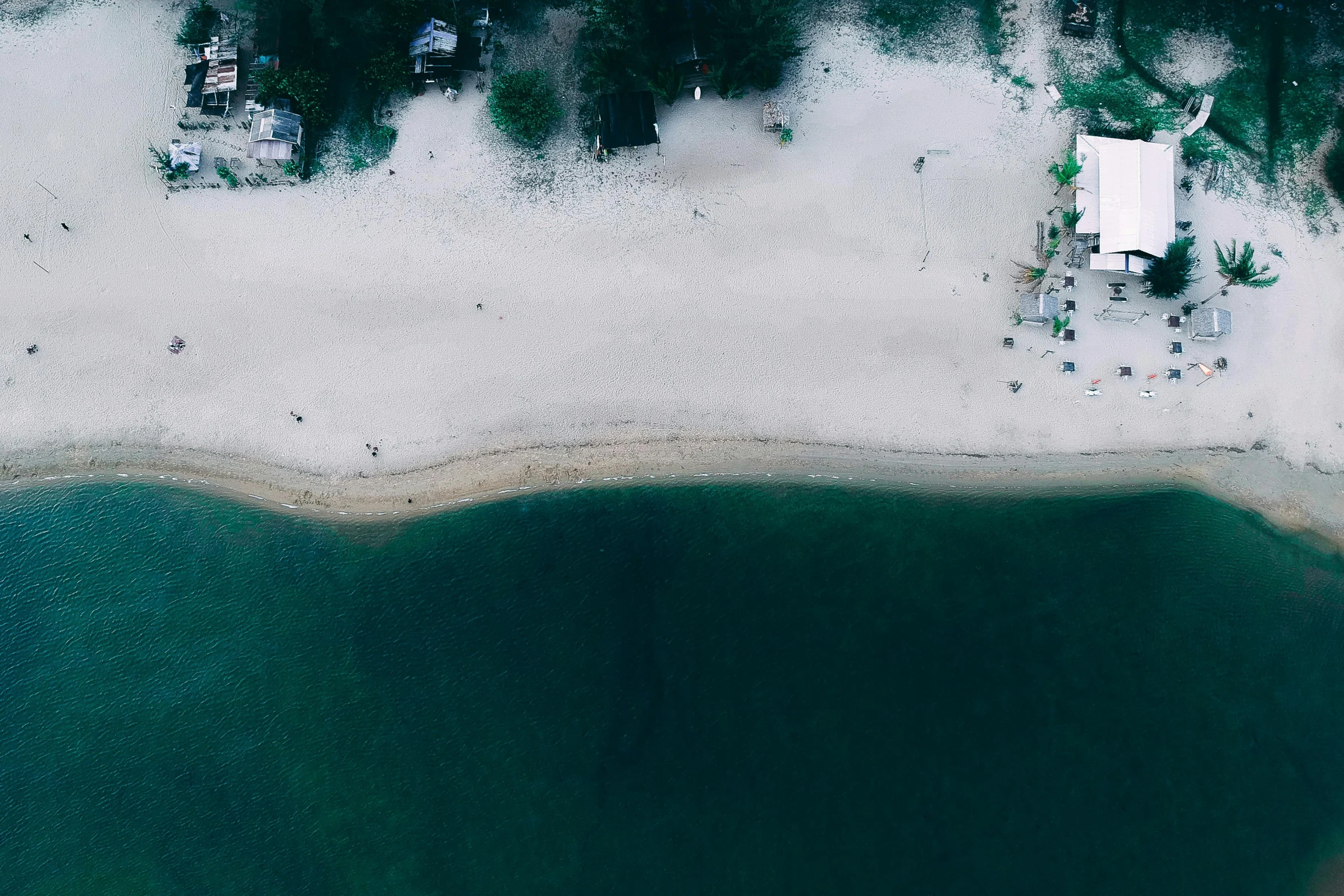 a large body of water next to a sandy beach, pexels contest winner, satelite imagery, thumbnail, neighborhood, grainy footage