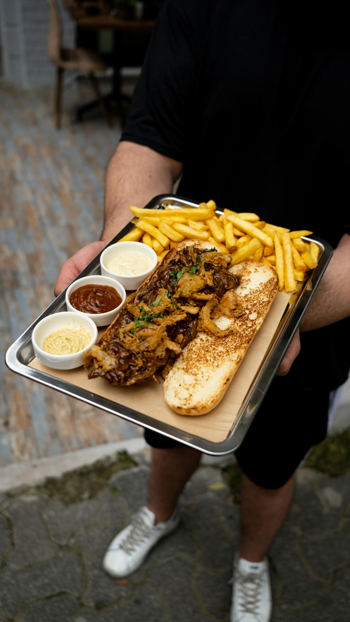 a man holding a tray with food on it, mad cuttlefish, with fries, manly, shot with sony alpha 1 camera