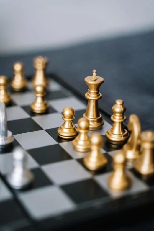 a chess board with gold and silver pieces, trending on unsplash, thumbnail, slide show, jen atkin, looking partly to the left