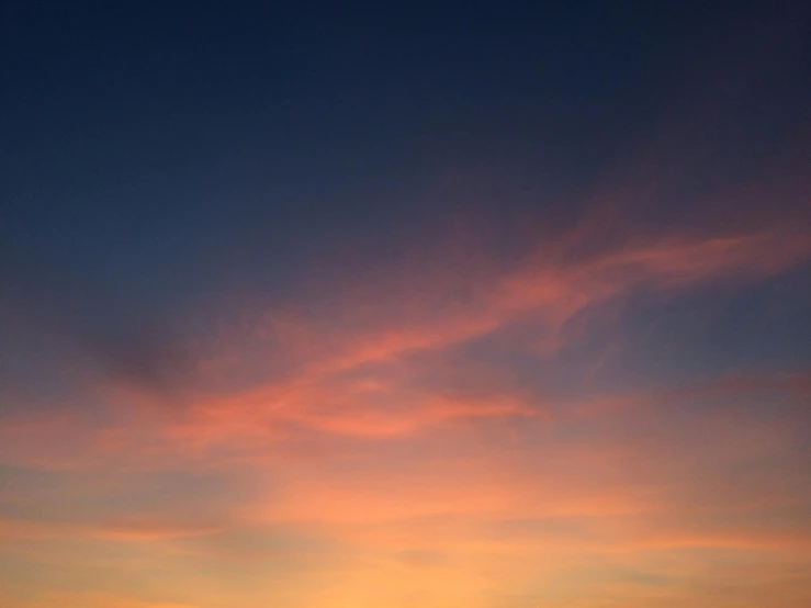 a large body of water with a sunset in the background, by Carey Morris, unsplash, minimalism, light red and deep blue mood, low-angle, ceremonial clouds, soft light - n 9