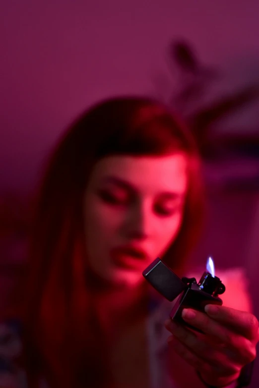 a woman holding a lighter in her hand, inspired by Nan Goldin, trending on pexels, renaissance, red and blue black light, low purple flame, petra collins and mc. escher, concentration
