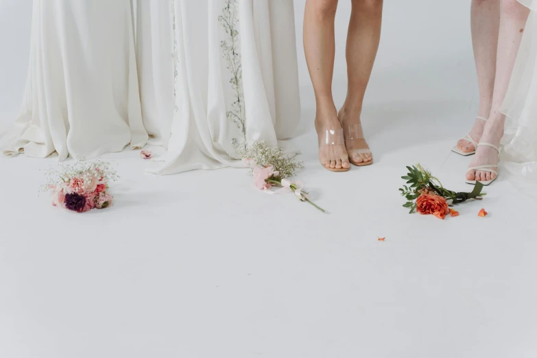 a group of women standing next to each other, an album cover, inspired by Victorine Foot, trending on pexels, romanticism, bed of flowers on floor, wearing heels and white dress, transparent background, detail shot