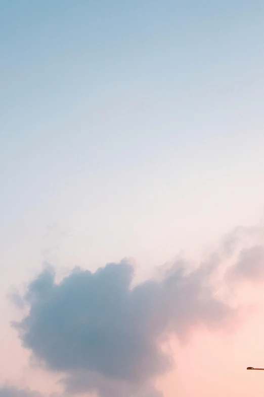 a large jetliner sitting on top of an airport tarmac, unsplash, aestheticism, pink tinged heavenly clouds, minimalist photo, pink and blue colour, vertical wallpaper