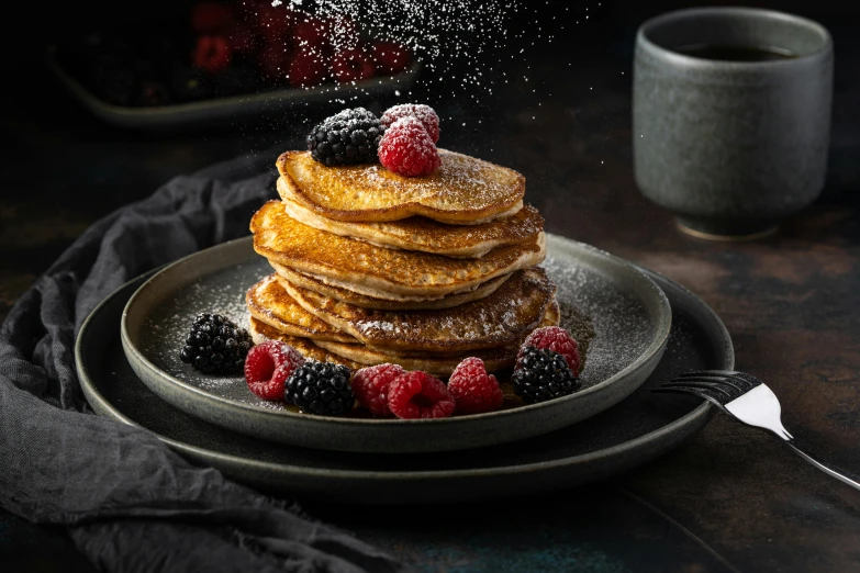 a stack of pancakes topped with berries and powdered sugar, a portrait, unsplash, medium format, black, shot with sony alpha 1 camera, background image