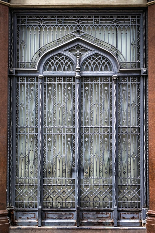 a black fire hydrant sitting in front of a building, inspired by Gustav Doré, art nouveau, iron gate door texture, chrome cathedrals, glass window, seen from outside