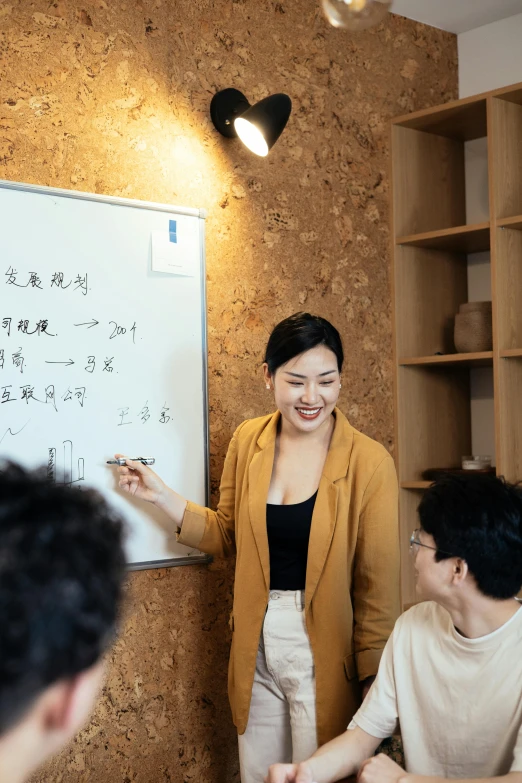 a woman giving a presentation to a group of people, by Jang Seung-eop, trending on unsplash, art & language, 千 葉 雄 大, multiple stories, chinese woman, whiteboard