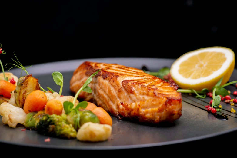 a close up of a plate of food on a table, fish tail, offering a plate of food