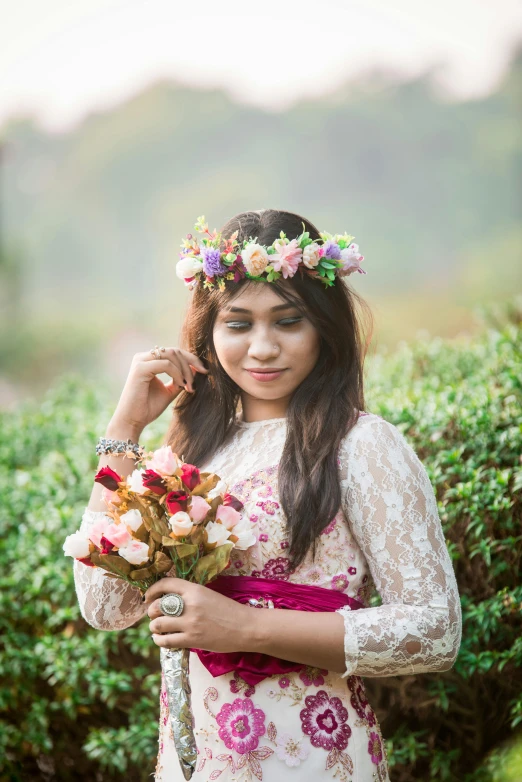 a beautiful young woman holding a bunch of flowers, inspired by reyna rochin, pexels contest winner, nepal, floral crown, teen, lush surroundings