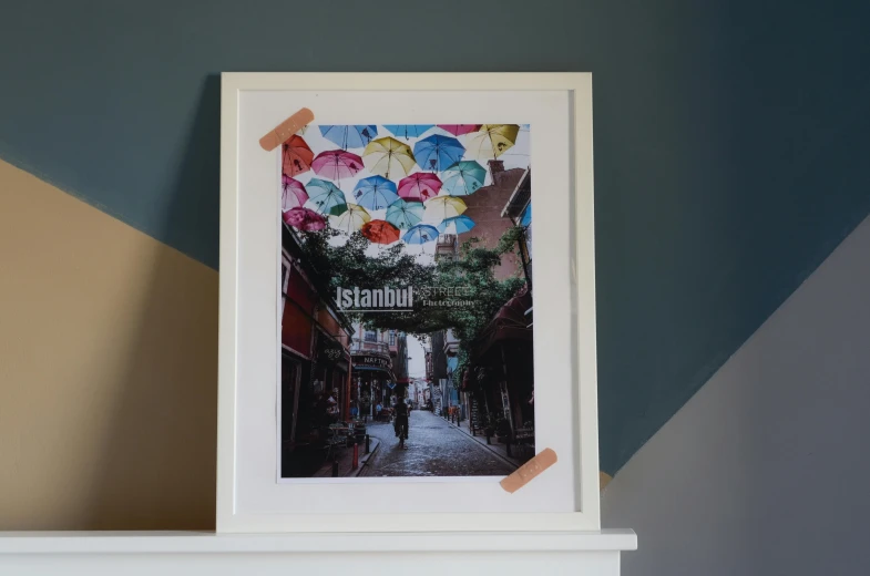 a picture of a street with umbrellas on it, poster art, inspired by Osman Hamdi Bey, unsplash contest winner, temporary art, white frame, istanbul, photographic print, 1990s photograph