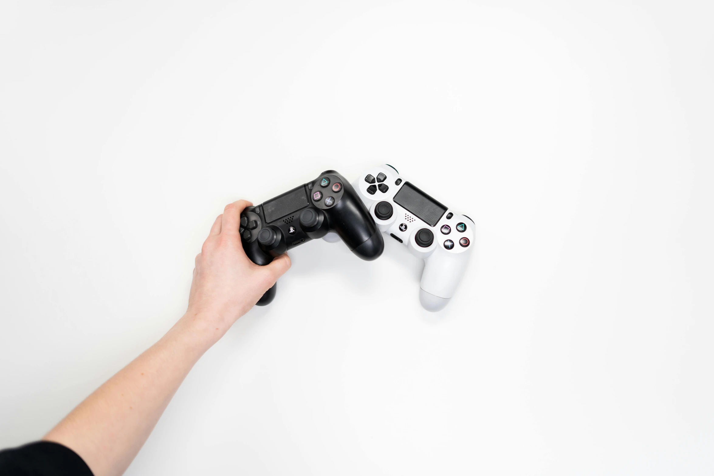 a person holding a video game controller in their hand, by Carey Morris, unsplash, minimalism, dueling, white and black, first playstation graphics, 15081959 21121991 01012000 4k