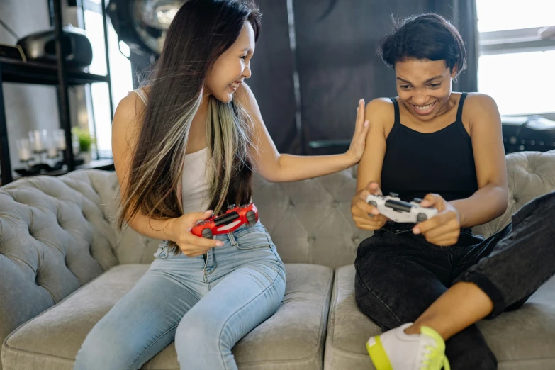 two women sitting on a couch playing video games, pexels contest winner, avatar image, sport game, instagram post, male and female