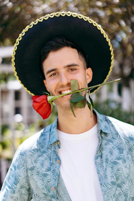 a man in a sombren with a rose in his mouth, an album cover, inspired by Germán Londoño, pexels contest winner, wearing sombrero, cute young man, daniel ricciardo, kyle mclaughlin