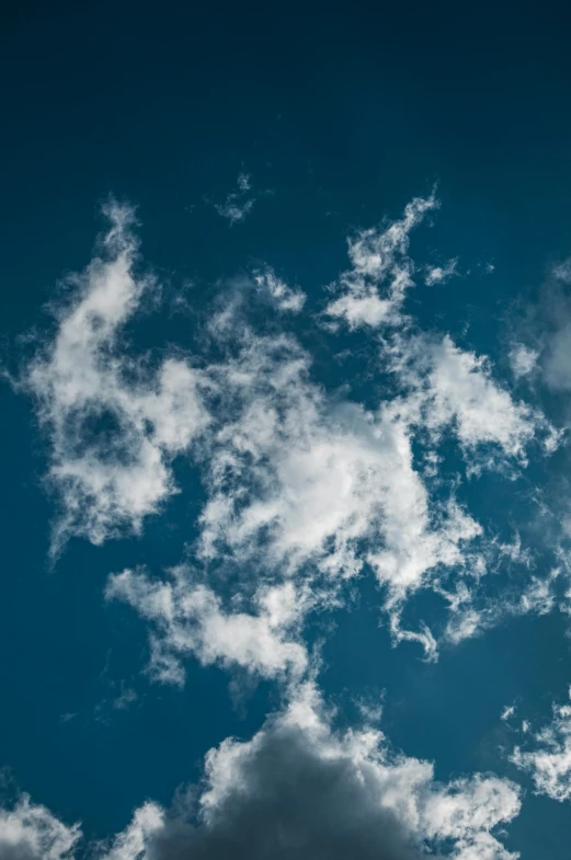 a jetliner flying through a cloudy blue sky, an album cover, inspired by Jan Rustem, unsplash, minimalism, fluffy white clouds, spores floating in the air, ignant, recognizable