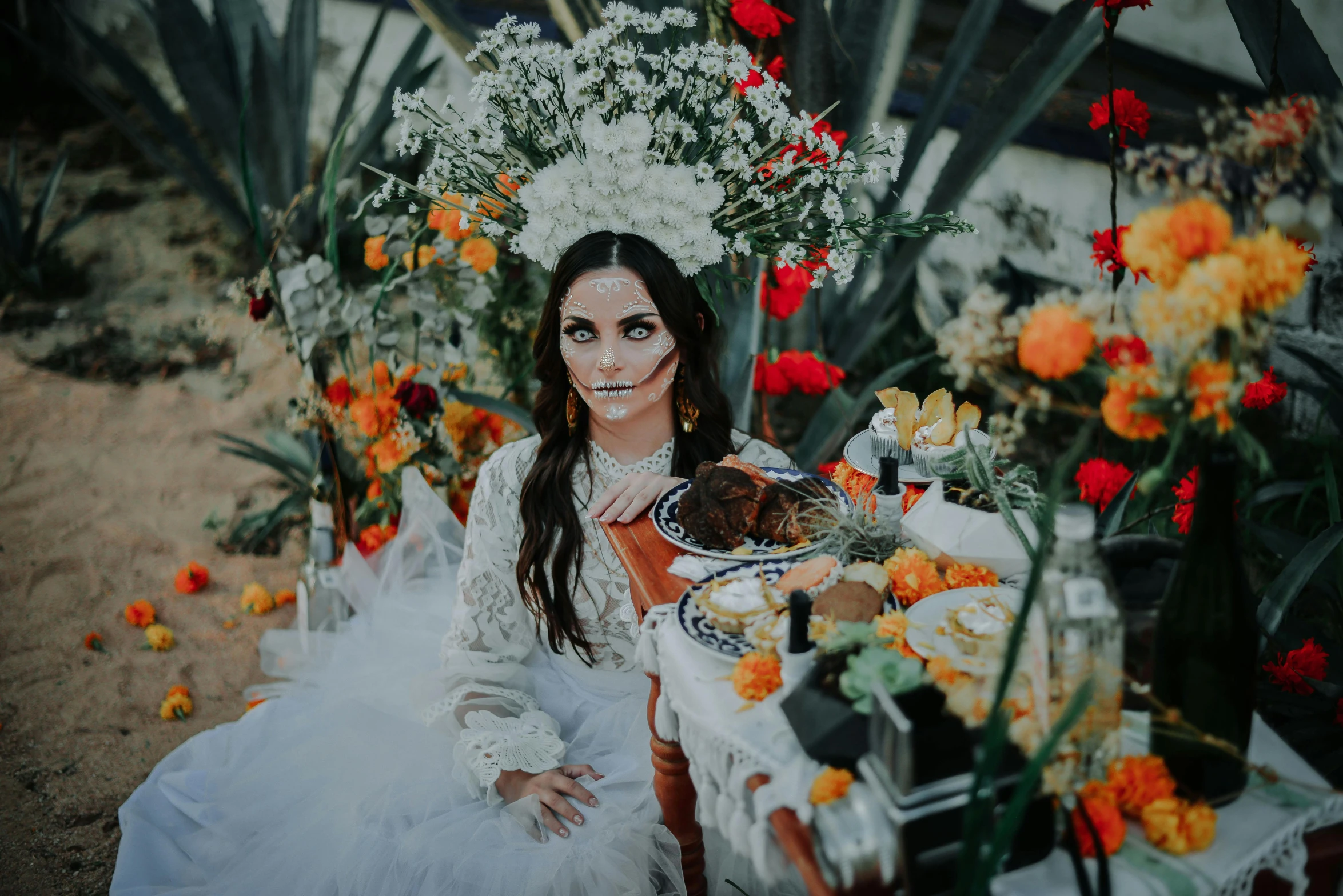 a woman in a white dress sitting in front of flowers, inspired by Kahlo, pexels contest winner, halloween theme, on a table, jessica nigri, white and orange