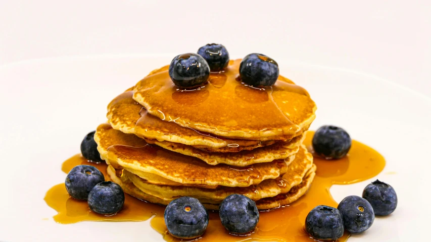 a stack of pancakes sitting on top of a white plate, product image, blueberries on the side, sun coast, thumbnail