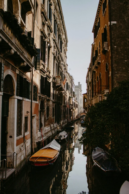 a canal filled with lots of boats next to tall buildings, pexels contest winner, renaissance, shady alleys, sienna, vsco, late afternoon