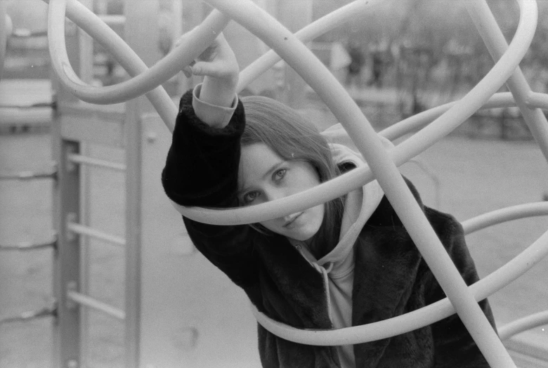 a black and white photo of a woman on a playground, inspired by Cornelia Parker, clarice starling, 7 0 s cinestill, softplay, square