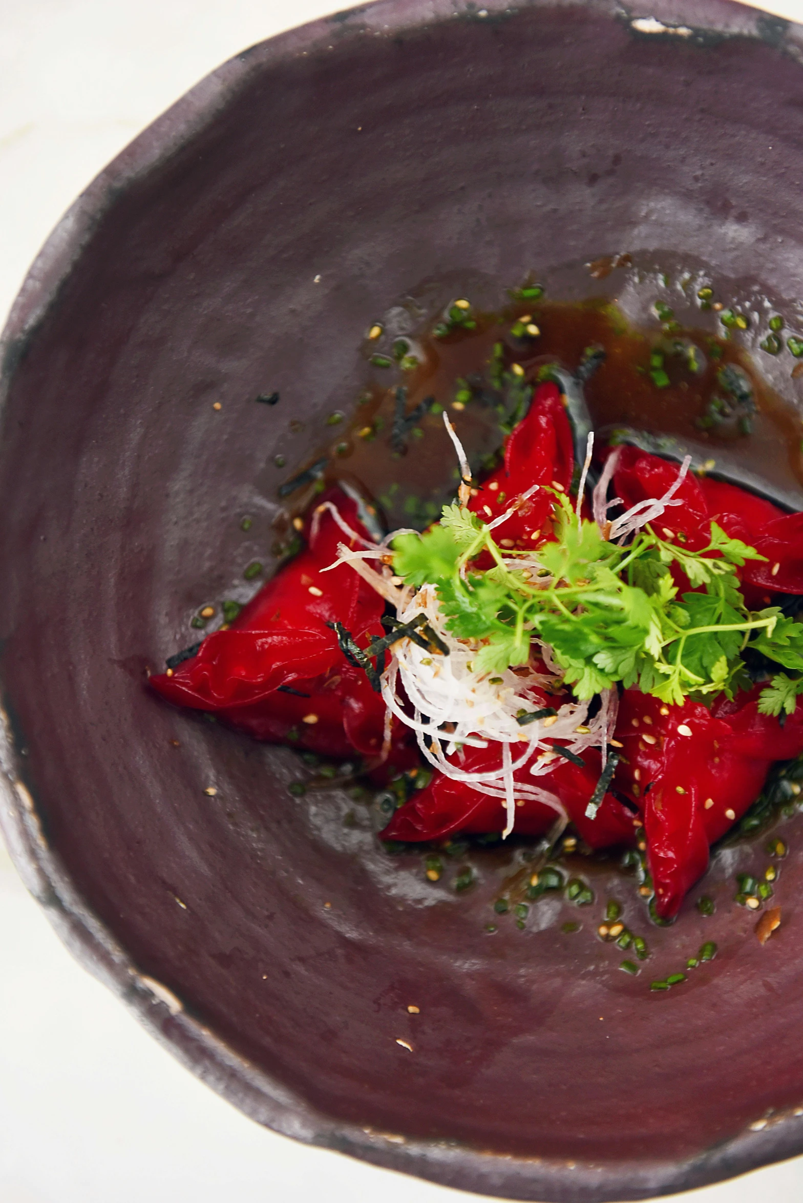 a close up of a bowl of food on a table, inspired by Asai Chū, beets, back shark fin, body with black and red lava, ignant