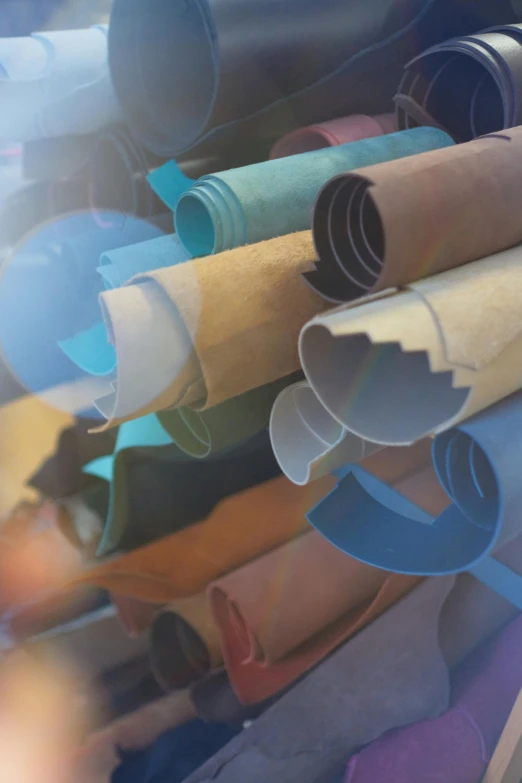 a bunch of different colored rolls of paper, by Dan Christensen, renaissance, blurred and dreamy illustration, rusty pipes, promo image, electron microscope image