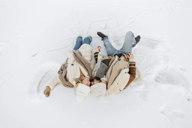 a group of people laying in the snow, by Emma Andijewska, pexels contest winner, white, brown, designed for cozy aesthetics!, avatar image