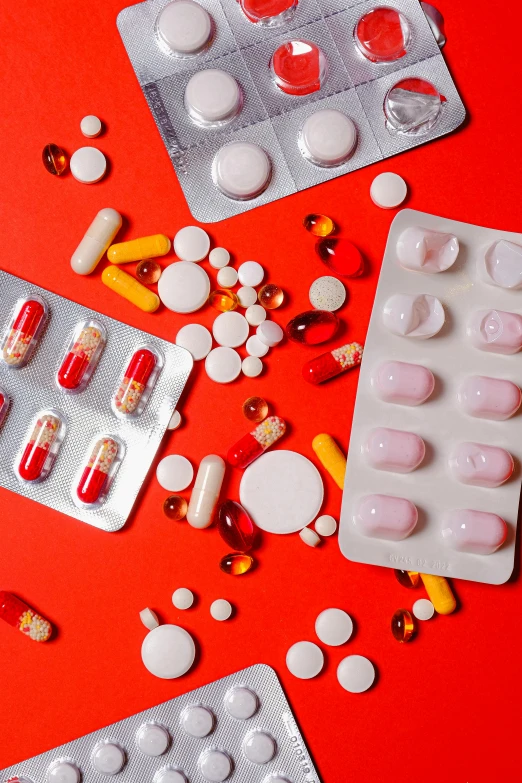 a bunch of pills sitting on top of a red table, by Julia Pishtar, plasticien, medical labels, flatlay, multiple stories, detailed product image