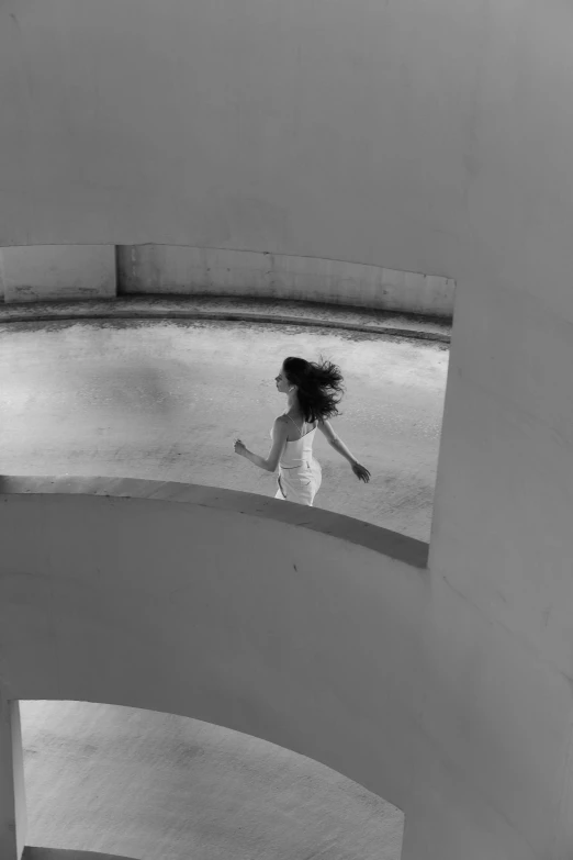 a black and white photo of a woman in a white dress, inspired by Sergio Larraín, in a swimming pool, running, in balcony of palace, curls