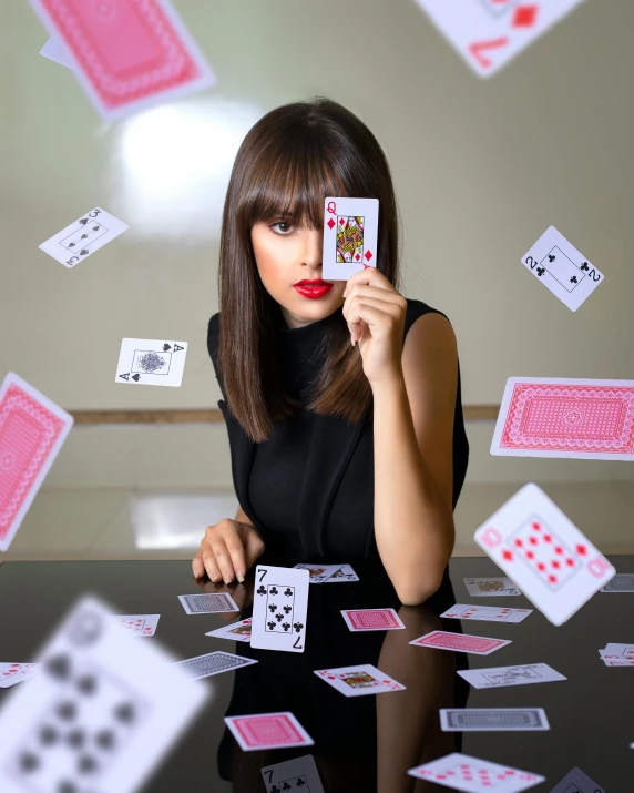 a woman sitting at a table surrounded by playing cards, an album cover, by Julia Pishtar, pexels contest winner, isabela moner, 15081959 21121991 01012000 4k, throwing cards in the air, portrait of vanessa morgan