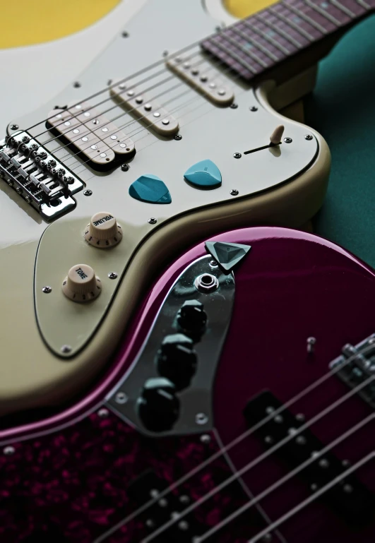 a close up of a guitar on a table, pexels contest winner, electric guitars, mauve and cyan, stingray, jeweled technology