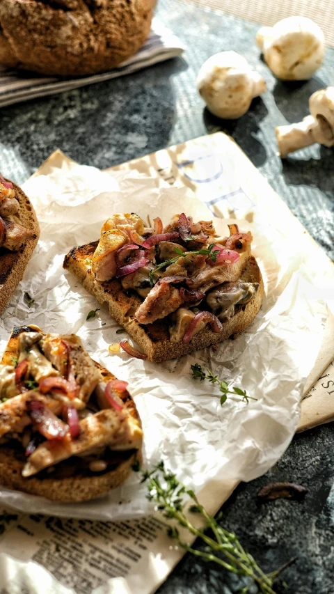 a bunch of food sitting on top of a piece of paper, a picture, toast, on parchment, thumbnail, angled shot