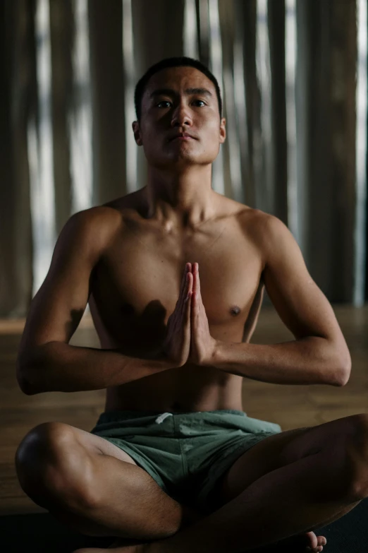 a man sitting in the middle of a yoga pose, a portrait, inspired by I Ketut Soki, unsplash, lean man with light tan skin, lgbtq, ignant, focus on torso