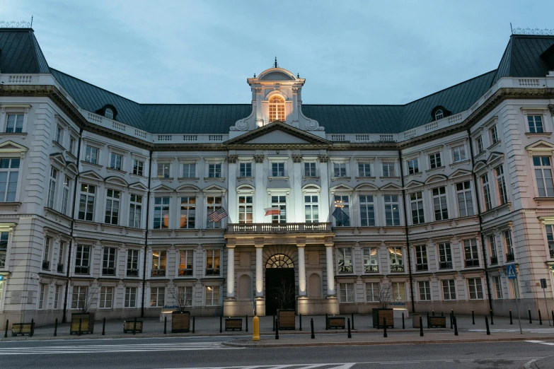 a large building with a clock tower on top of it, evening lighting, victoria siemer, uhq, royal court