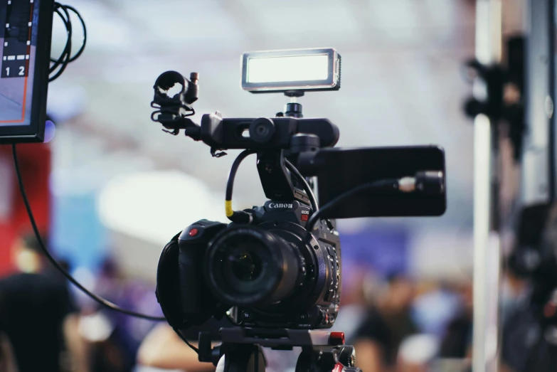 a close up of a camera on a tripod, unsplash, video art, sports broadcast, looking partly to the left, youtube thumbnail, concert