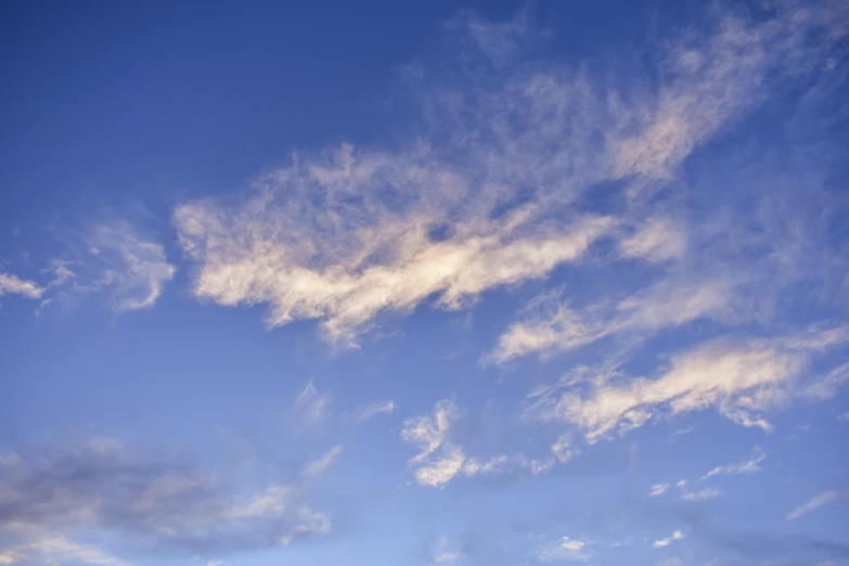 a man riding a snowboard on top of a snow covered slope, an album cover, unsplash, hurufiyya, layered stratocumulus clouds, late summer evening, sky blue, today\'s featured photograph 4k