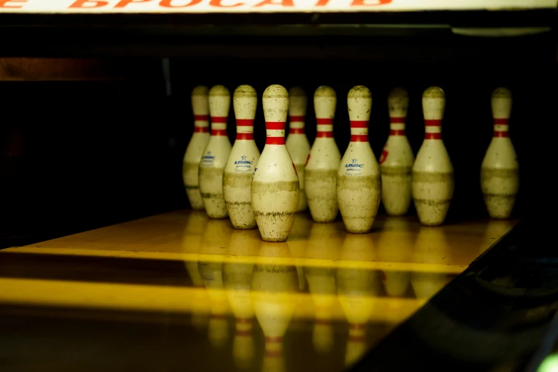 a row of bowling pins sitting on top of a wooden table
