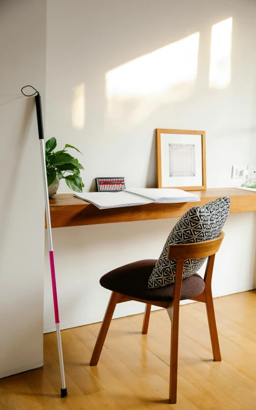 a chair and a desk in a room, by Jessie Algie, unsplash, minimalism, with a walking cane, studyng in bedroom, panoramic shot, dwell