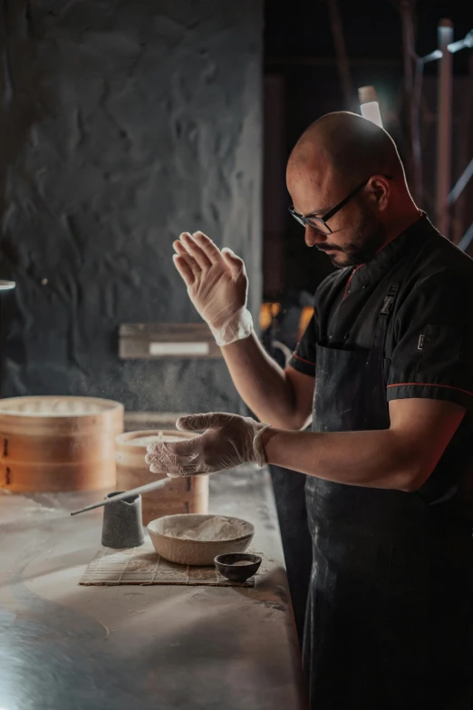 a man standing in a kitchen preparing food, process art, steamed buns, on a dark background, pestle, profile image